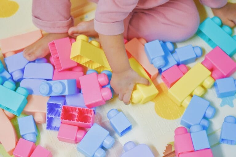 close up of child s hand playing plastic toy build 2025 02 03 10 54 56 utc