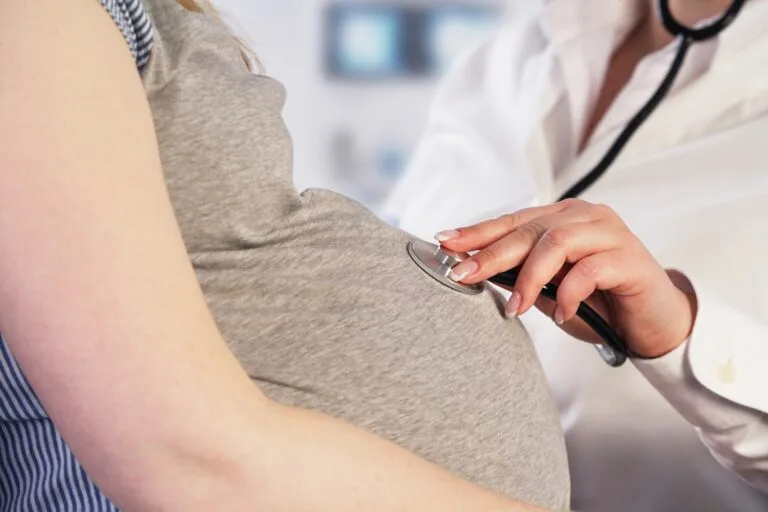 Home 16 Doctor examining a pregnant woman.