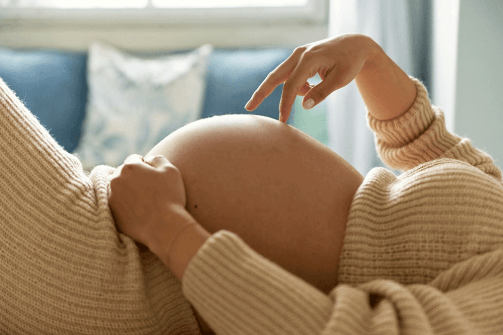 A pregnant woman excited to be in her second trimester.