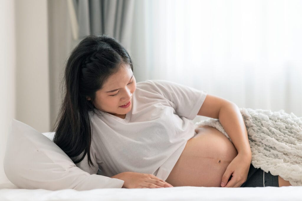 pregnant woman feeling something in her belly